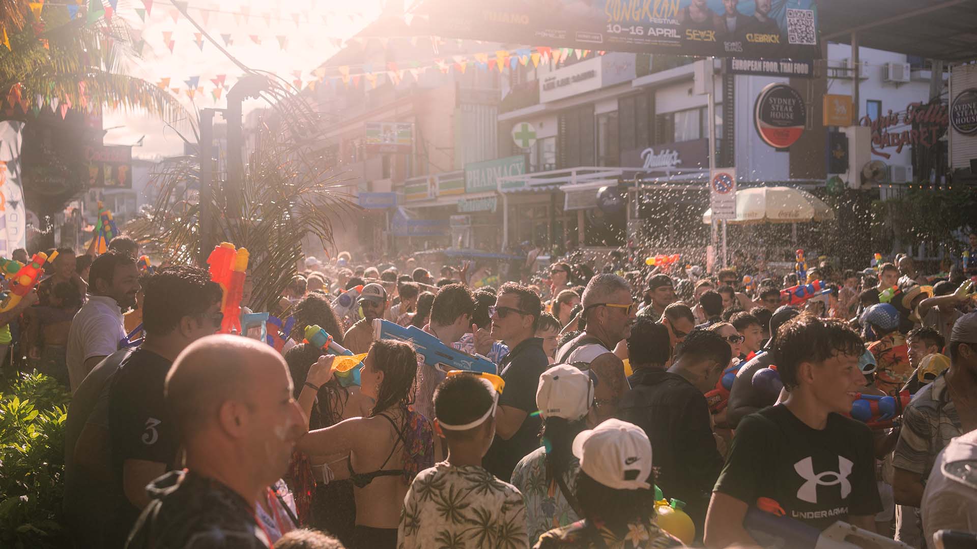 Crowds celebrating Songkran Koh Samui 2026 on Chaweng Beach Road during the main water fight day in April