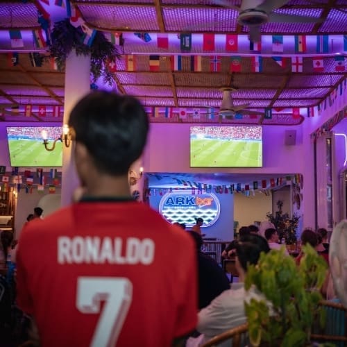 Football fan in a Ronaldo shirt watching the World Cup on multiple screens at HIP Restaurant, Chaweng, Koh Samui